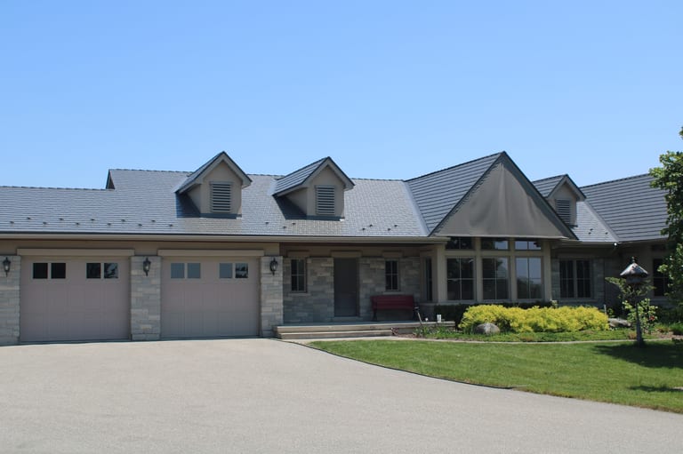 Musket Grey Interlock Cedar Shingle aluminum roof on a beige single-family home with a metal roof in a suburban, Guelph, Ontario