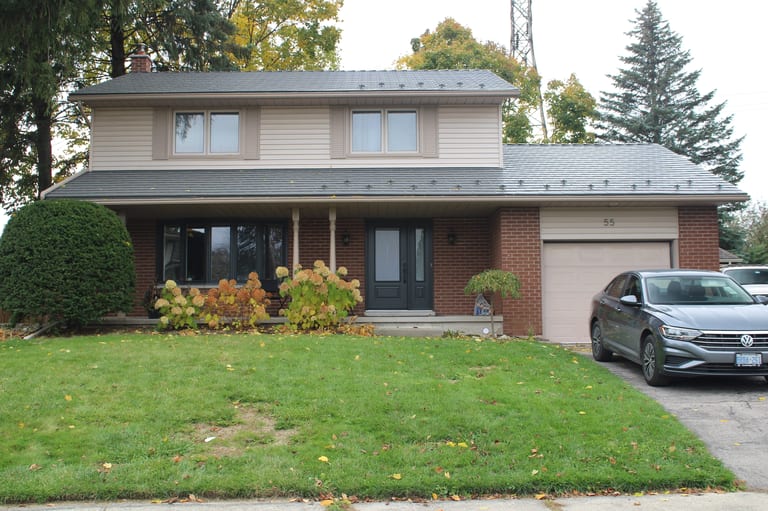 Musket Grey Interlock Cedar Shingle aluminum roof on a two-storey colonial home with a red brick facade and a, Kitchener, Ontario