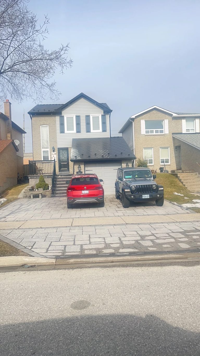 Black Interlock Slate aluminum roof on a tan single-family home with a black metal roof and a grey, Brampton, Ontario