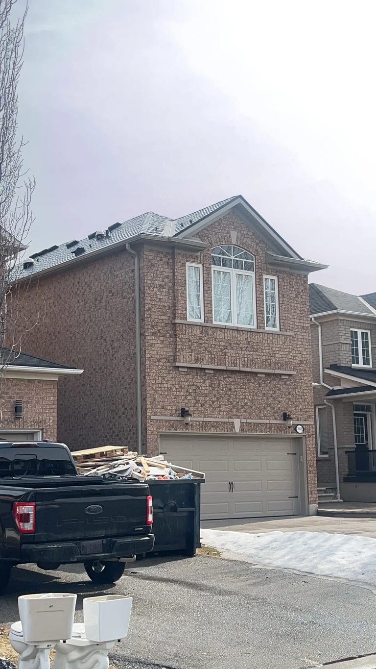 Deep Charcoal Interlock Slate aluminum roof on a brick two-storey home with dormers and a metal roof, Mississauga, Ontario