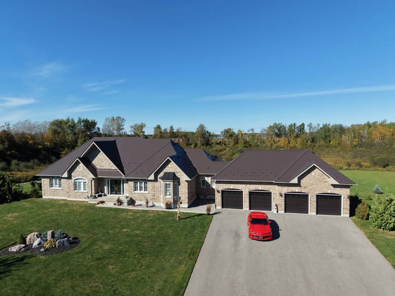 Tudor Brown Interlock Slate aluminum roof on a Tudor brown metal roof on a ranch style home in the forest, Kawartha Lakes, Ontario