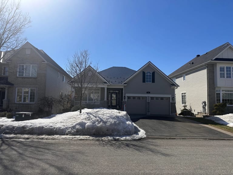 Black Interlock Slate aluminum roof on a beige single-family home with snow in a residential area, Ottawa, Ontario