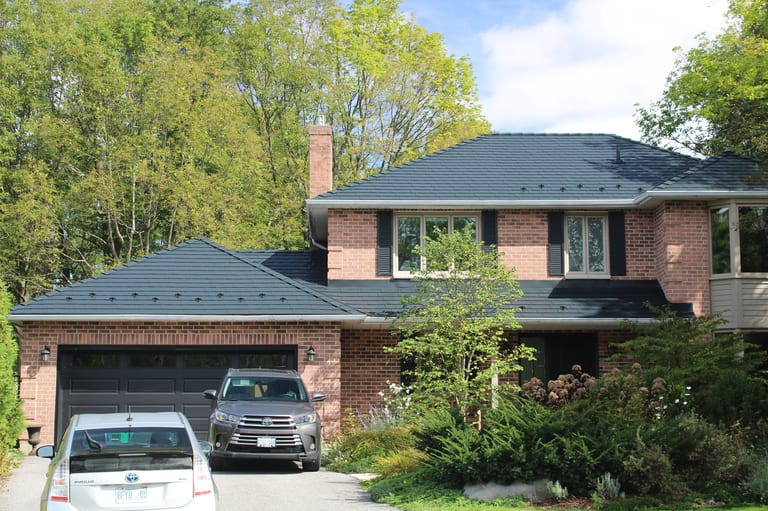 Black Interlock Slate aluminum roof on a two-storey brick home with a black metal roof in a, Kingston, Ontario