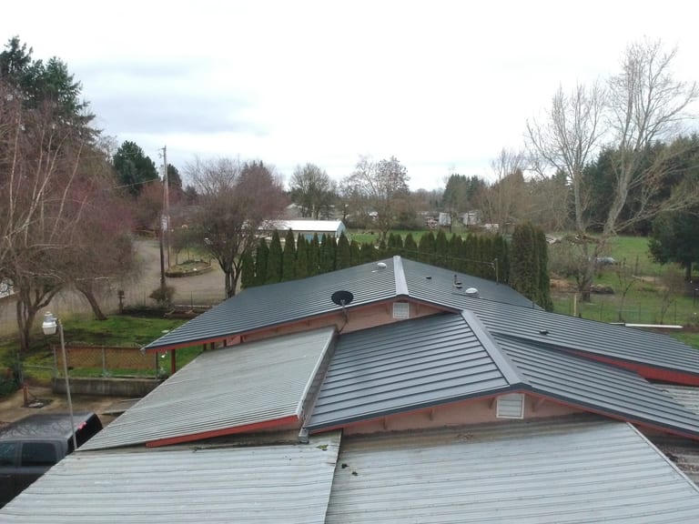 Deep Charcoal Interlock Standing Seam aluminum roof on a metal roofed ranch style home in a rural setting, Scio, Oregon