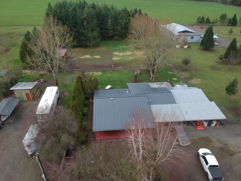 Deep Charcoal Interlock Standing Seam aluminum roof on a deep charcoal metal roof on a ranch style home in a rural, Scio, Oregon
