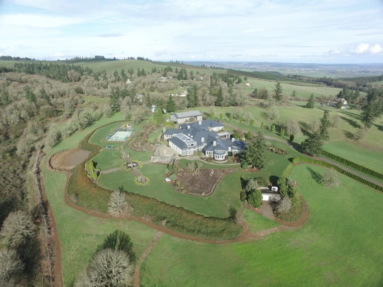 Deep Charcoal Interlock IB Membrane aluminum roof on a single-storey home with dormers on a sprawling green lawn, Turner, Oregon