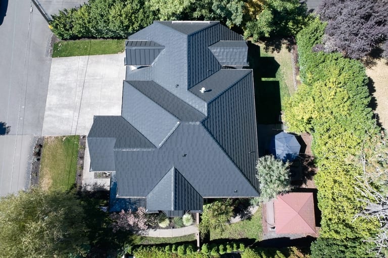 Deep Charcoal Interlock Shake aluminum roof on a dark home with a metal roof and a well-manicured front, Portland, Oregon
