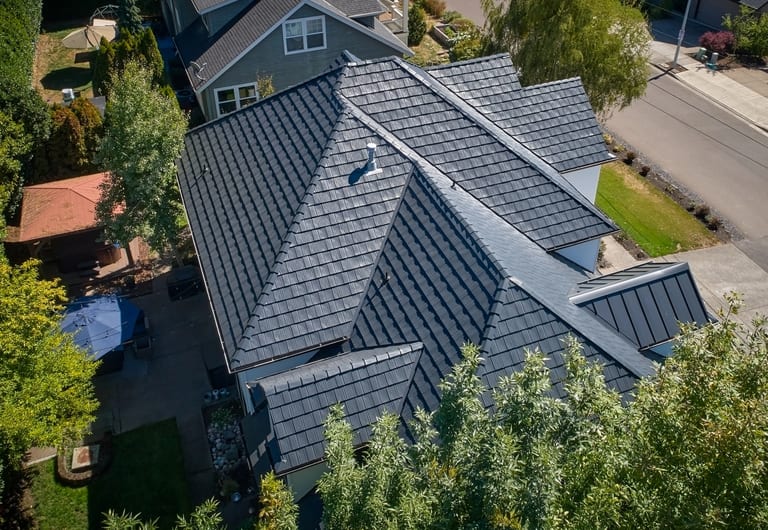Deep Charcoal Interlock Shake aluminum roof on a grey two-storey home with a metal roof in a suburban, Portland, Oregon