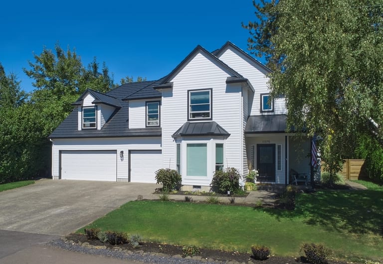 Deep Charcoal Interlock Shake aluminum roof on a white colonial home with a metal roof in a forested, Portland, Oregon