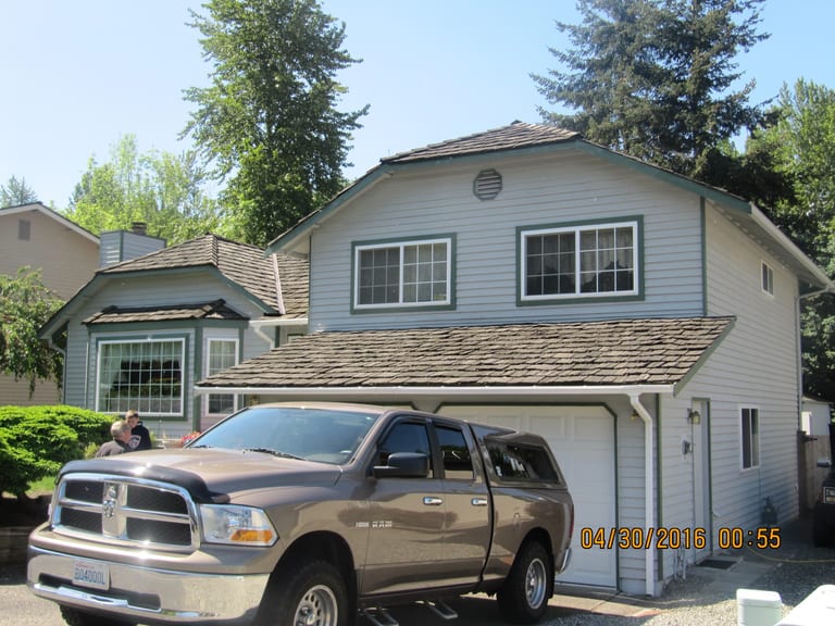 Before: Before: a worn out wood shake roof on the home, Renton, Washington, ahead of a Colonial Brown Interlock Cedar Shingle aluminum roof
