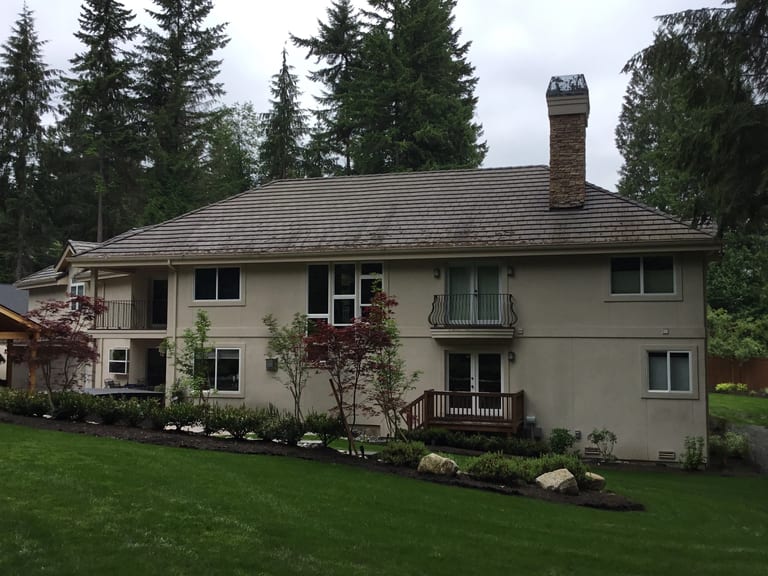 Before: Before: a worn out concrete tile roof on the home, Bothell, Washington, ahead of a Black Interlock Slate aluminum roof
