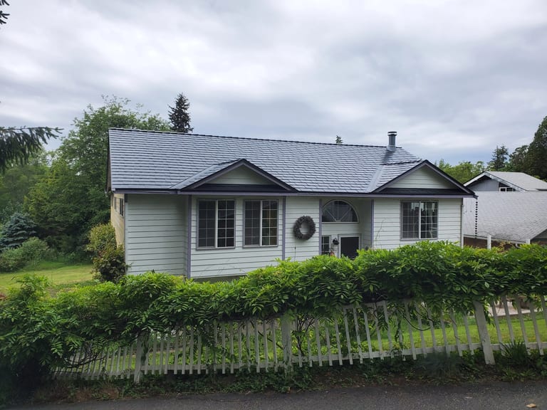 Black Interlock Slate aluminum roof on a white home with a metal roof in a rural setting, Bremerton, Washington