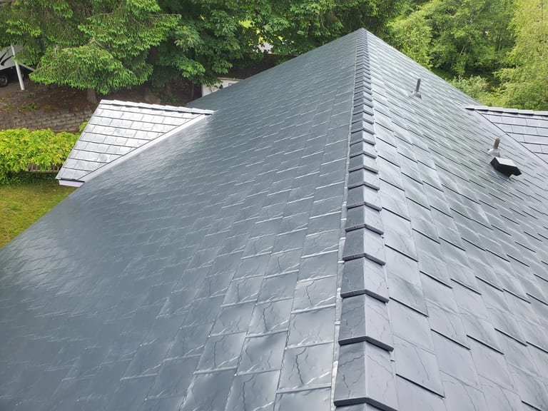 Black Interlock Slate aluminum roof on a black home with a metal roof in a forested rural area, Bremerton, Washington