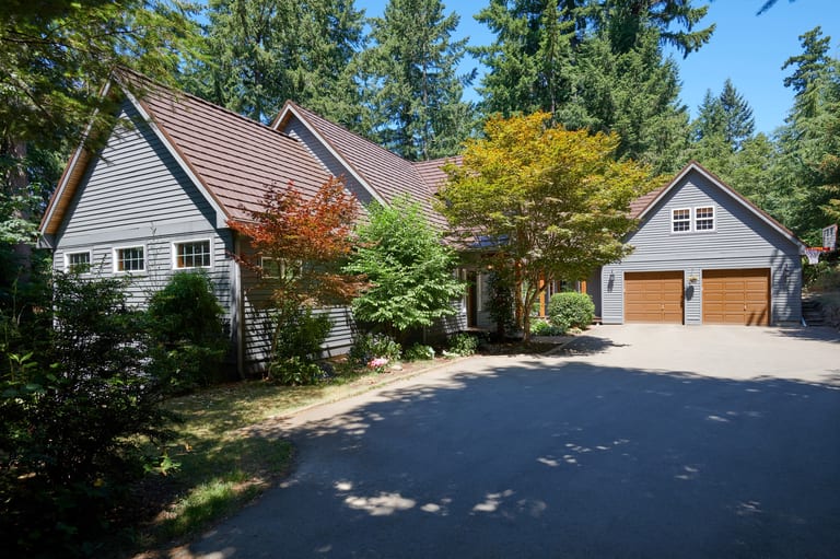 Colonial Brown Interlock Shake aluminum roof on a Colonial home in a forested area with a brown metal roof, Gig Harbor, Washington
