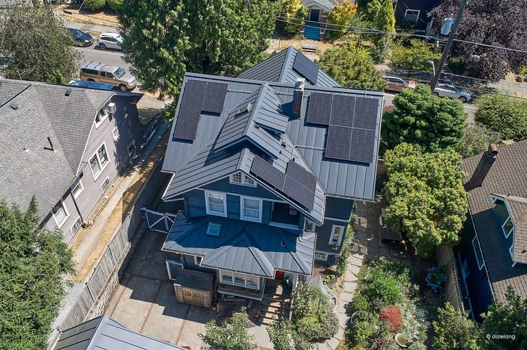 Deep Charcoal Interlock Standing Seam aluminum roof on a two-storey home with dormers in an urban setting, Seattle, Washington