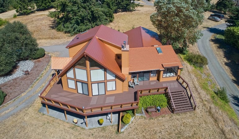 Copper Penny Interlock Cedar Shingle aluminum roof on a brown chalet-style home with a copper penny metal roof, Sequim, Washington