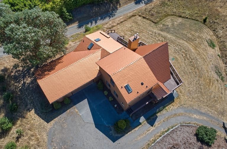Copper Penny Interlock Cedar Shingle aluminum roof on a large single-storey home with copper roof in a rural, Sequim, Washington