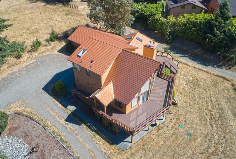 Copper Penny Interlock Cedar Shingle aluminum roof on a two-storey home with a copper penny metal roof in a rural, Sequim, Washington