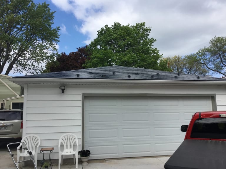 Charcoal Grey Interlock Slate aluminum roof on a white ranch home with a grey roof in a wooded suburban, Madison, Wisconsin