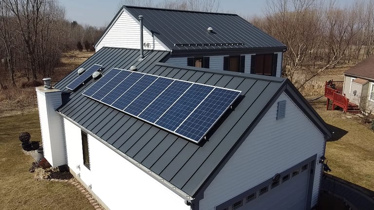 Interlock Standing Seam Metal Roofing installed on a contemporary residential home in Deep Charcoal, highlighting clean panel lines and seamless fastener-free surface.