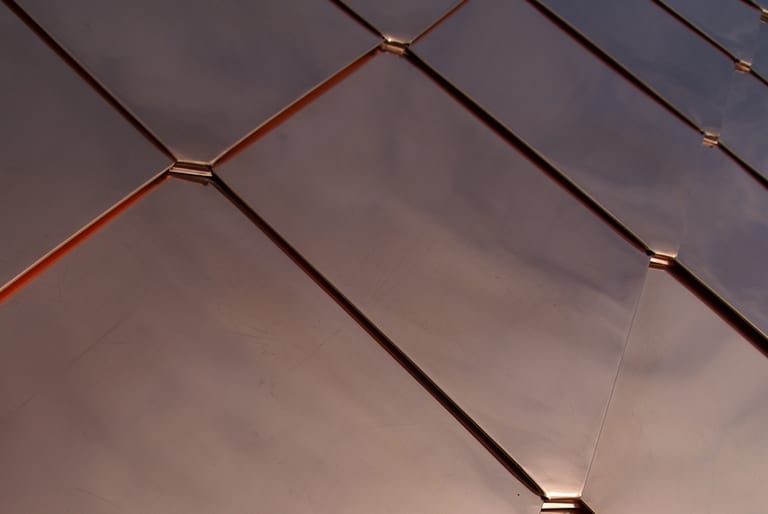 Interlock® Solid Copper Mediterranean Tile Roofing installations at various stages of natural patina development on Spanish Colonial, Italianate, and Mission residential architecture