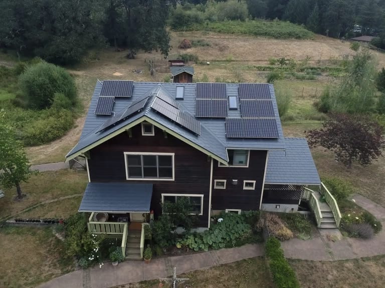 Aerial view of a Corvallis, Oregon home with rooftop solar panels on a Deep Charcoal Interlock slate aluminum roof