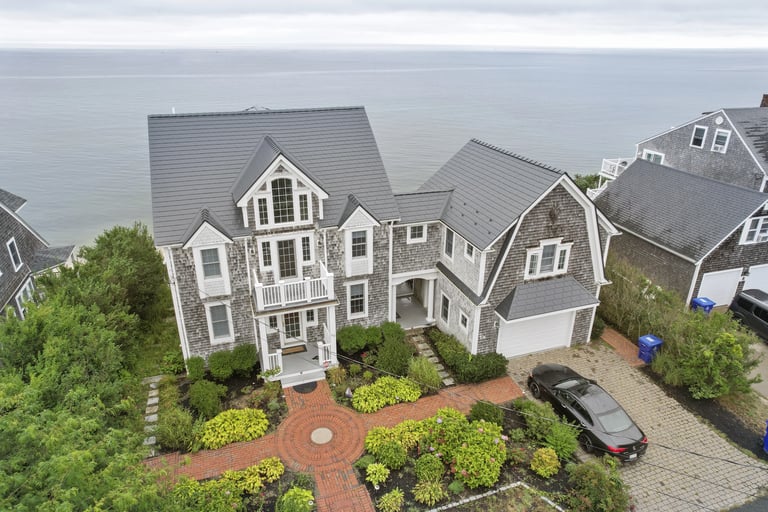 Gray Interlock aluminum roof on a shingle-sided home overlooking the ocean