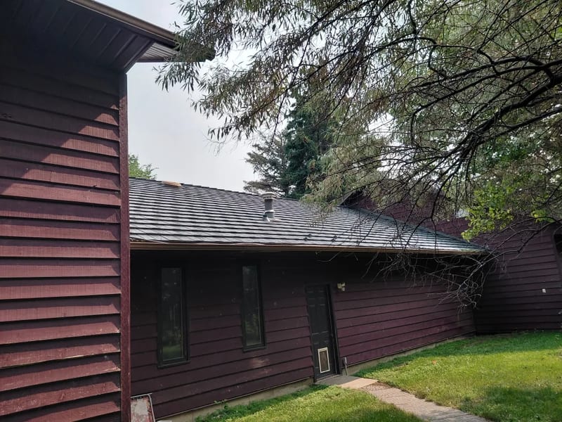 Musket Grey Interlock Shake aluminum roof on a brown ranch home with a grey metal roof in a rural setting, Warner, Alberta