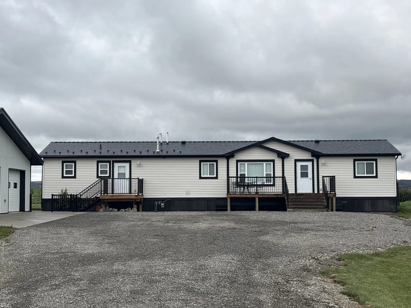 Black Interlock Cedar Shingle aluminum roof on a white ranch home with a black metal roof in a rural, Foothills County, Alberta