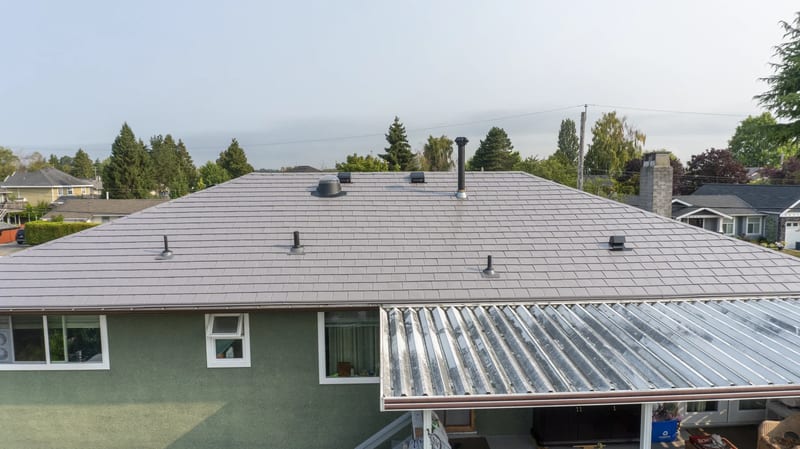 Taupe Interlock Slate aluminum roof on a taupe metal roof on a green ranch-style home in a, Delta, British Columbia