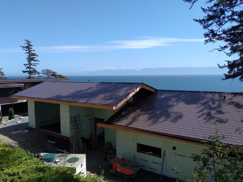 Tudor Brown Interlock Slate aluminum roof on a white single-family home with a Tudor brown metal roof, Shirley, British Columbia