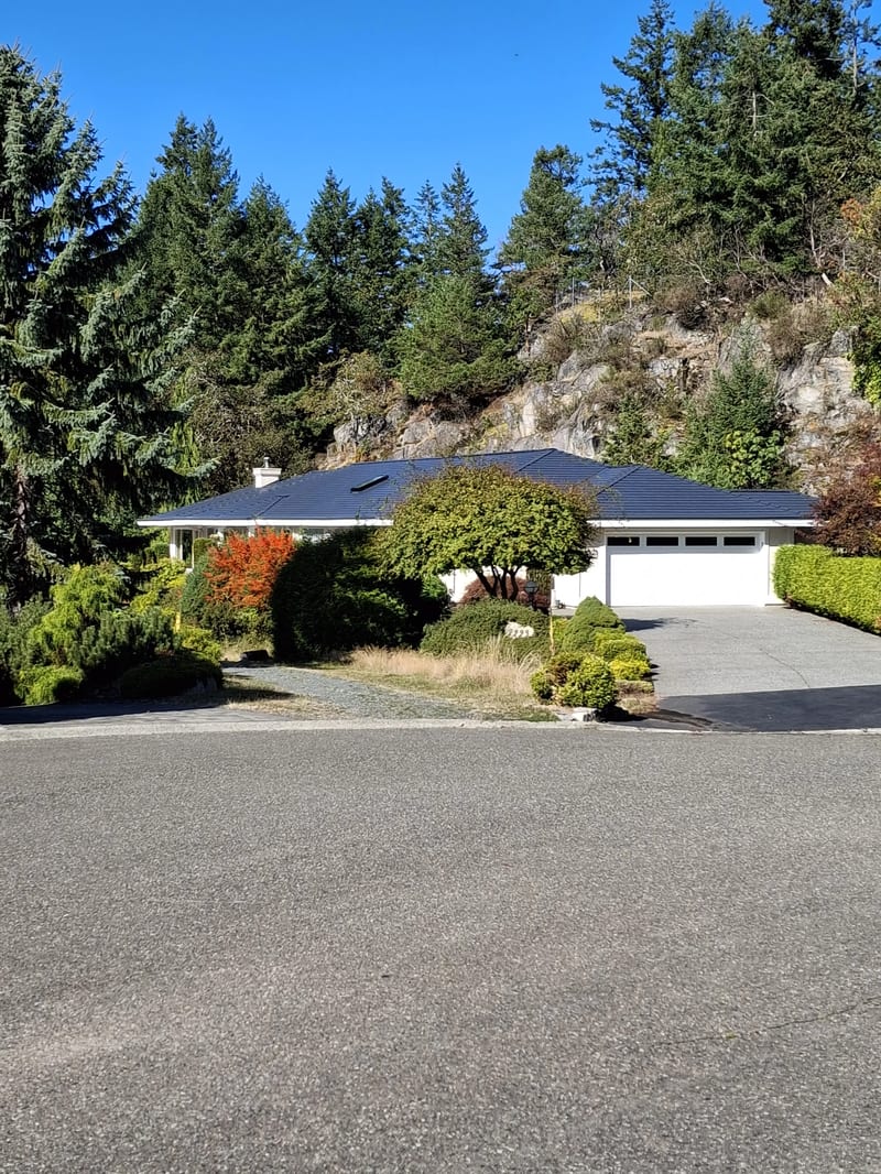 Deep Charcoal Interlock Slate aluminum roof on a single-storey home with a Deep Charcoal metal roof among, Nanoose Bay, British Columbia