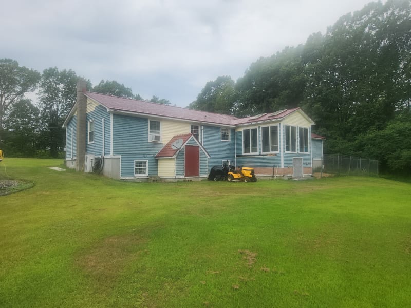 Tile Red Interlock aluminum roof installed on a Lebanon, Maine home.
