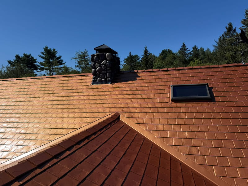 Copper Penny Interlock Slate metal roofing on a Maine home, lifetime warranty.