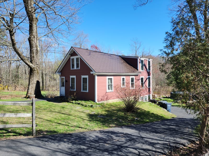 Colonial Brown Interlock metal shingle roof on a home in Jefferson, Massachusetts.