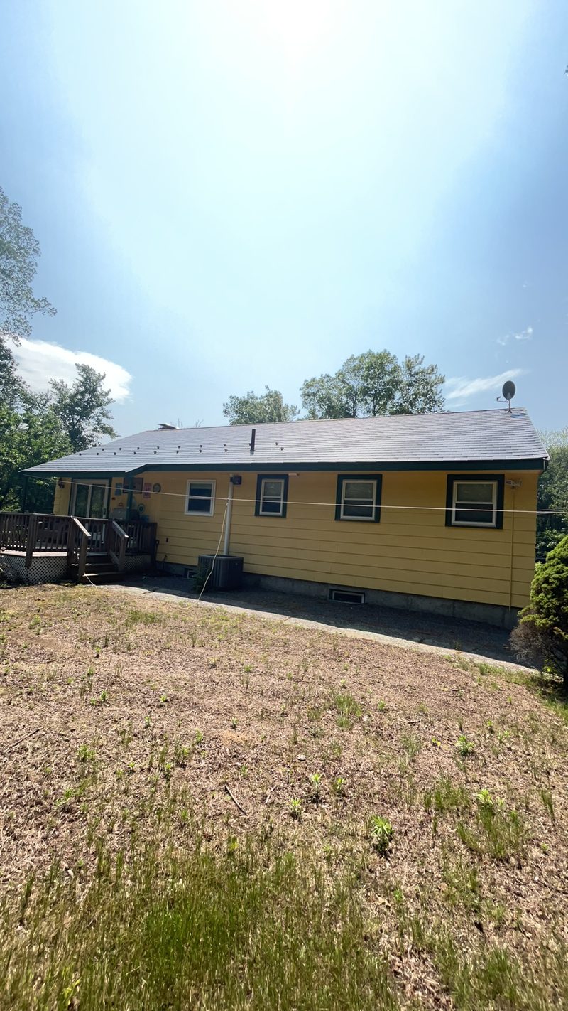 Charcoal Grey Interlock slate metal roofing on a Norfolk, Massachusetts home.