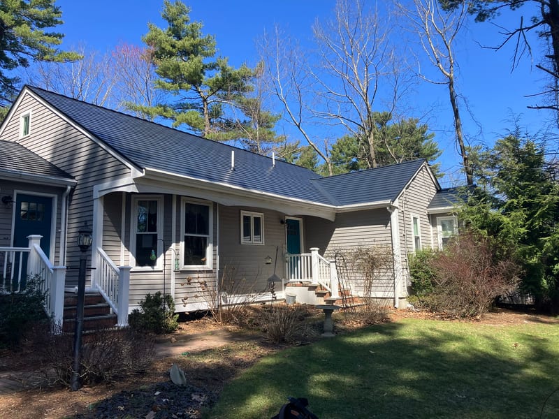 Black Interlock cedar shingle aluminum metal roof installation in Stoughton, MA.