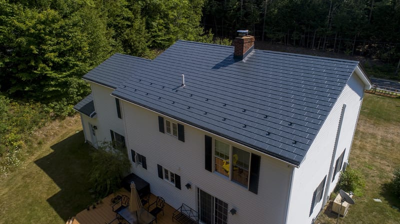 Charcoal Grey Interlock Slate metal roofing on a Webster, New Hampshire home with a warranted