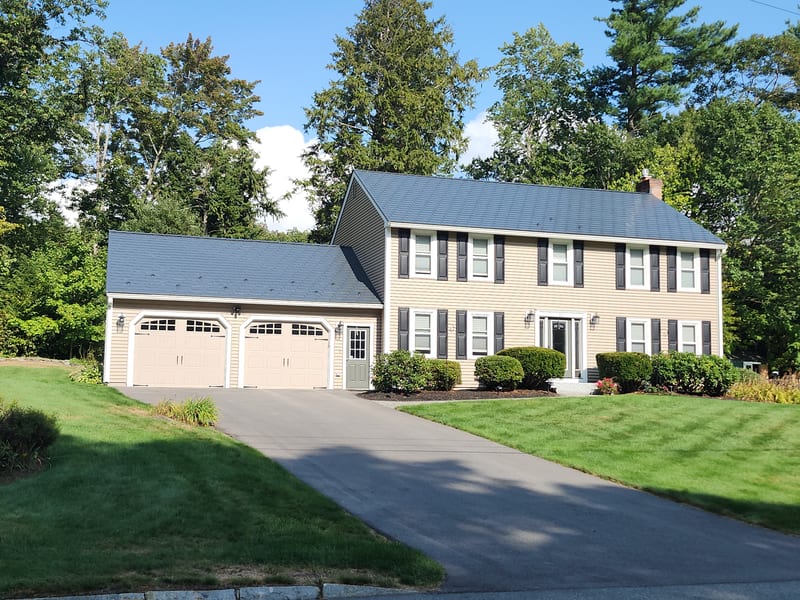 Deep Charcoal Interlock aluminum metal roof on a Nashua, NH home with attached garage.