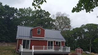 Deep Charcoal Interlock standing seam aluminum roof on a red home in Scituate, Rhode Island.