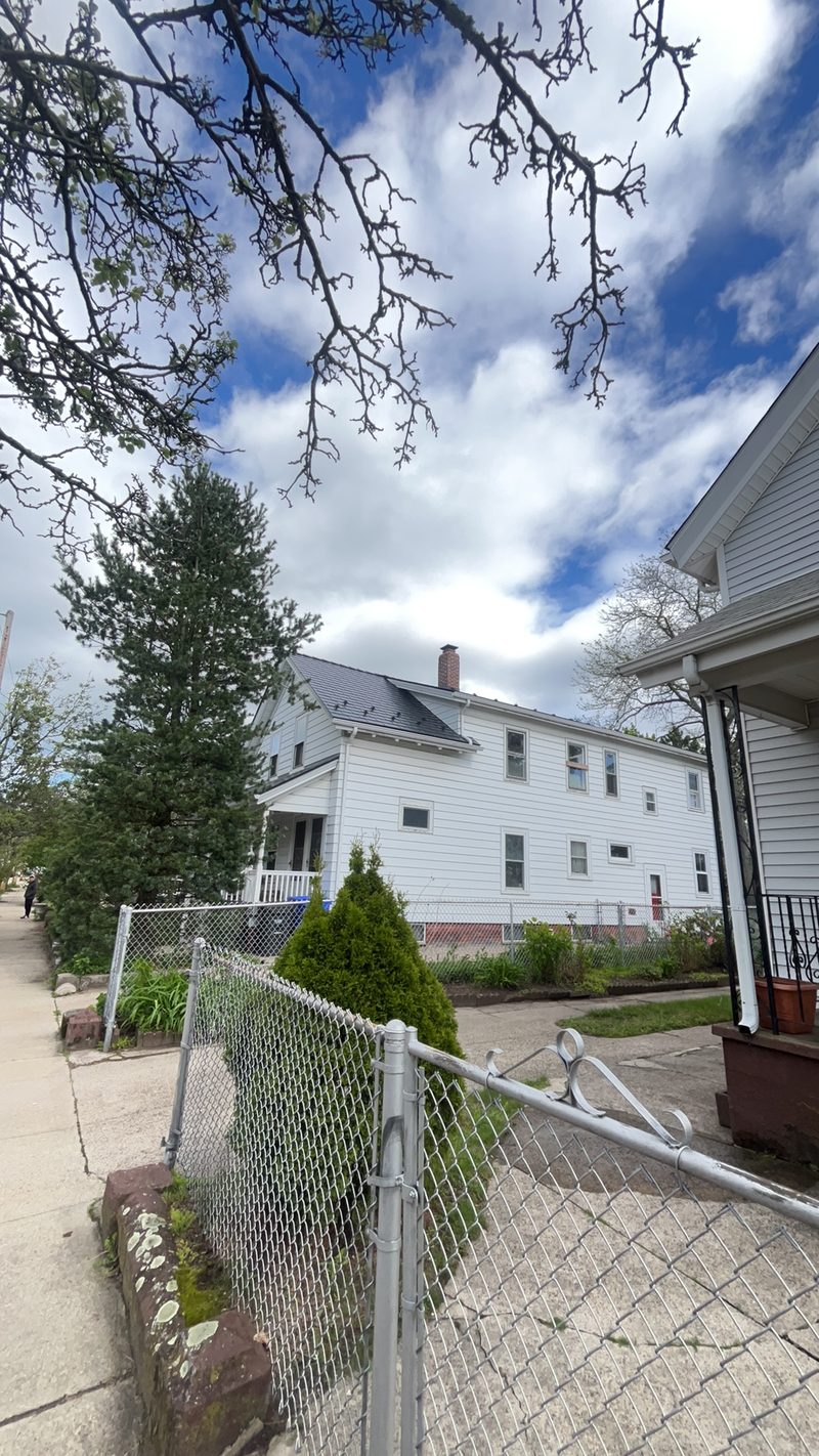 Black Interlock Slate aluminum metal roof on a Pawtucket, Rhode Island home, lifetime warranty installation.