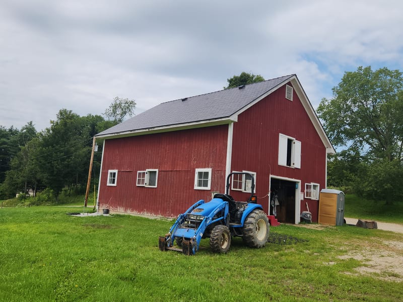 Tudor Brown Interlock Slate metal roof on a red barn in Brandon, Vermont.