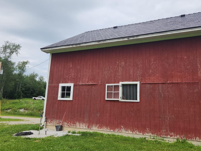 Tudor Brown Interlock Slate aluminum metal roof on a red barn in Brandon, Vermont.