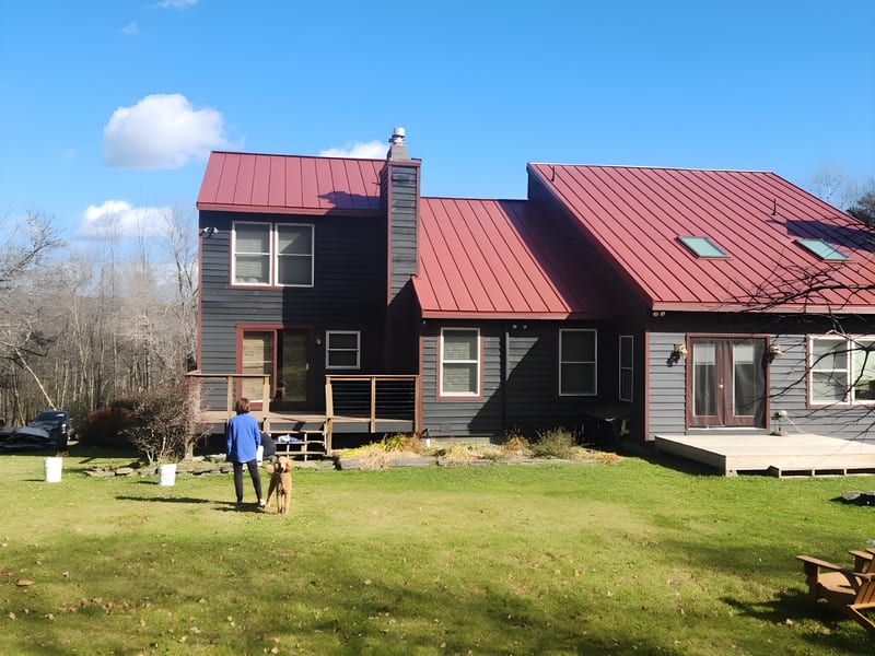 Tile Red Interlock metal roof on a home in Dover, Vermont.