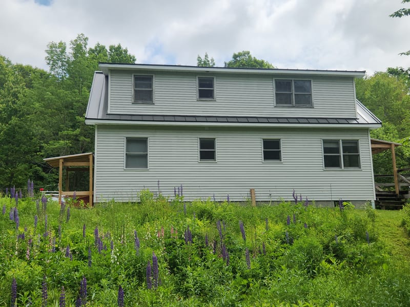 Musket Grey Interlock standing seam metal roof on a home in Jericho, Vermont.
