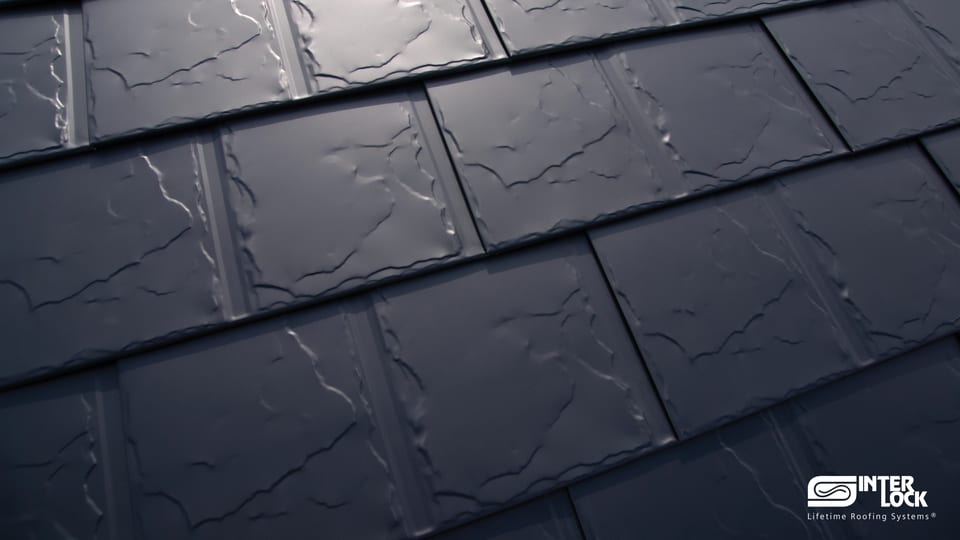 Close-up of an Interlock® aluminum roofing panel — slate profile finished with the Alunar® coating system