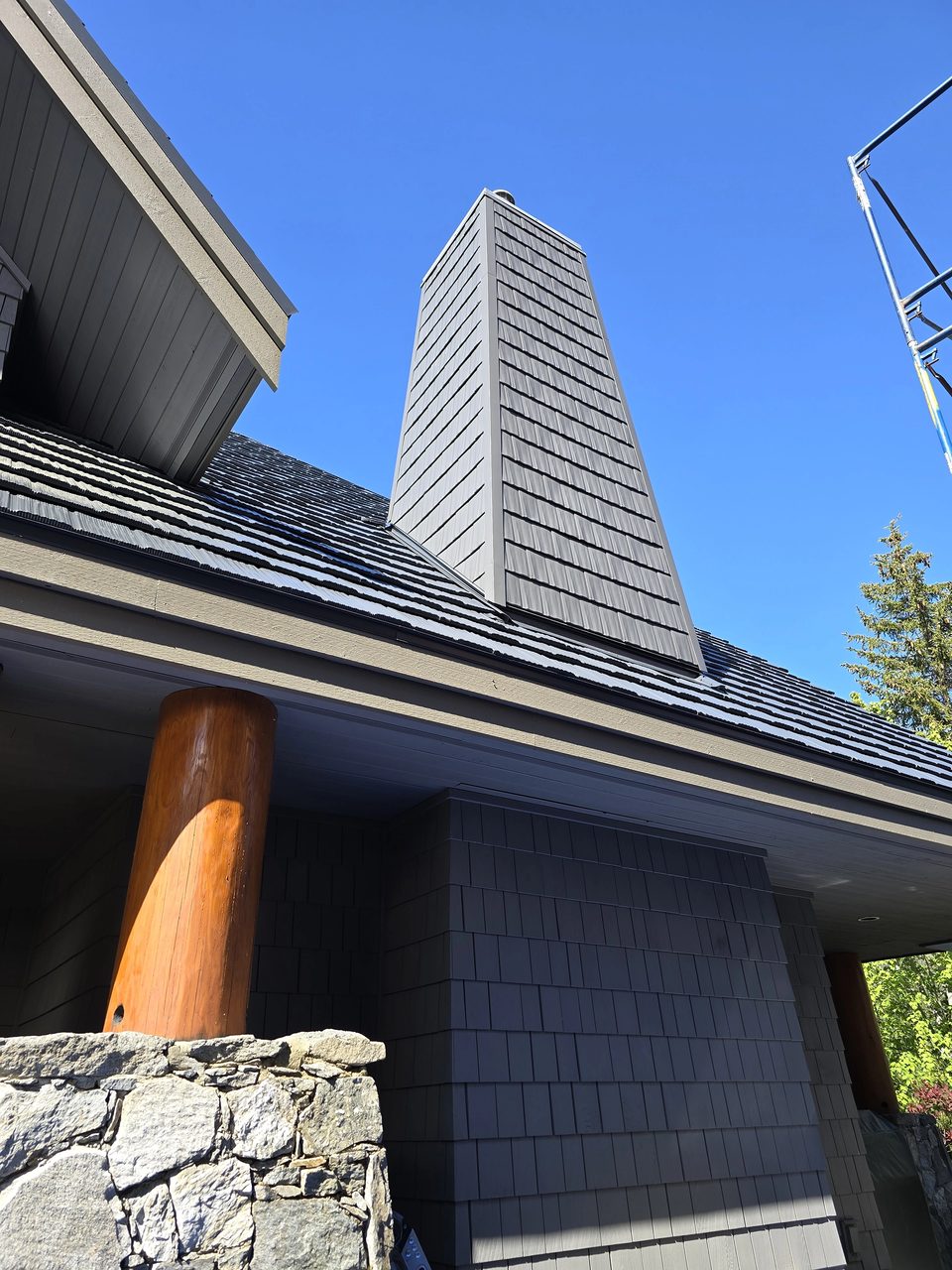 Deep Charcoal aluminum cedar shingle wall cladding on a chimney tower in Whistler, BC