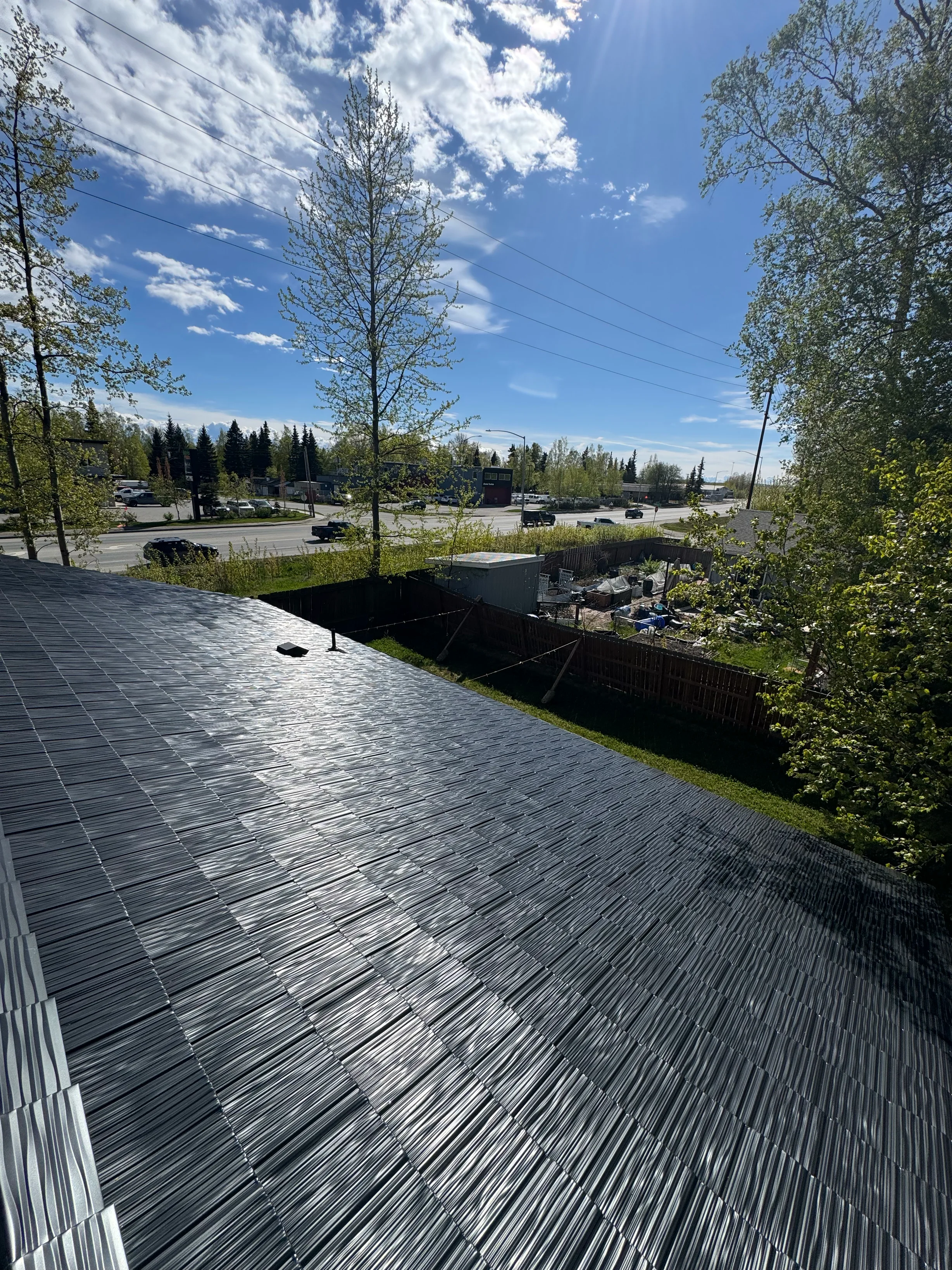 Black Interlock Shake aluminum roof on a black home with a metal roof in a wooded area, Anchorage, Alaska