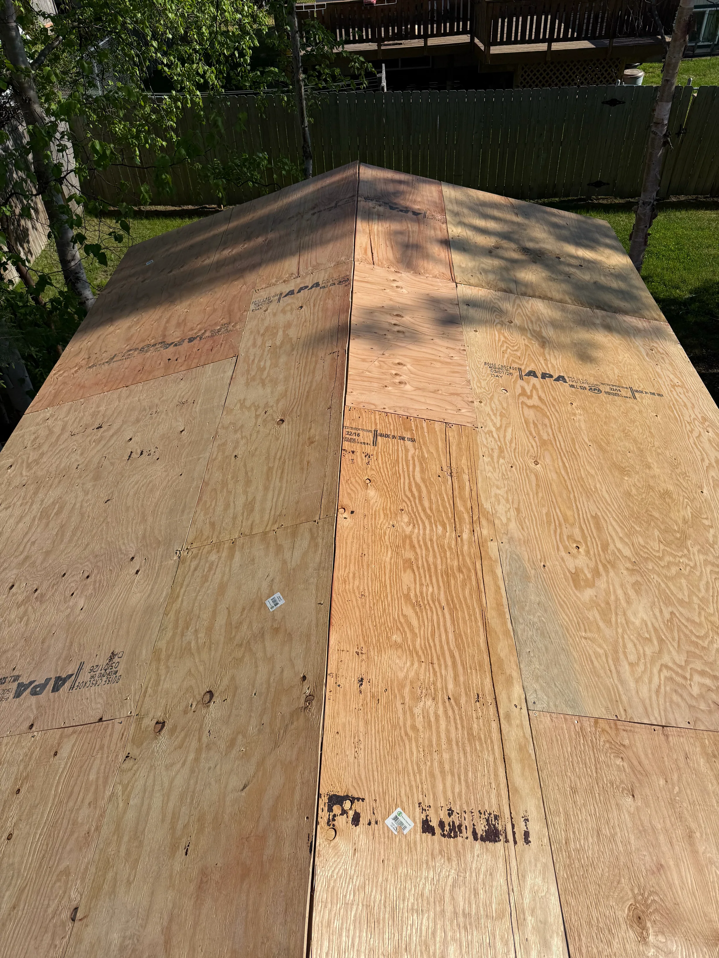 A new metal roof under construction in a rural setting.
