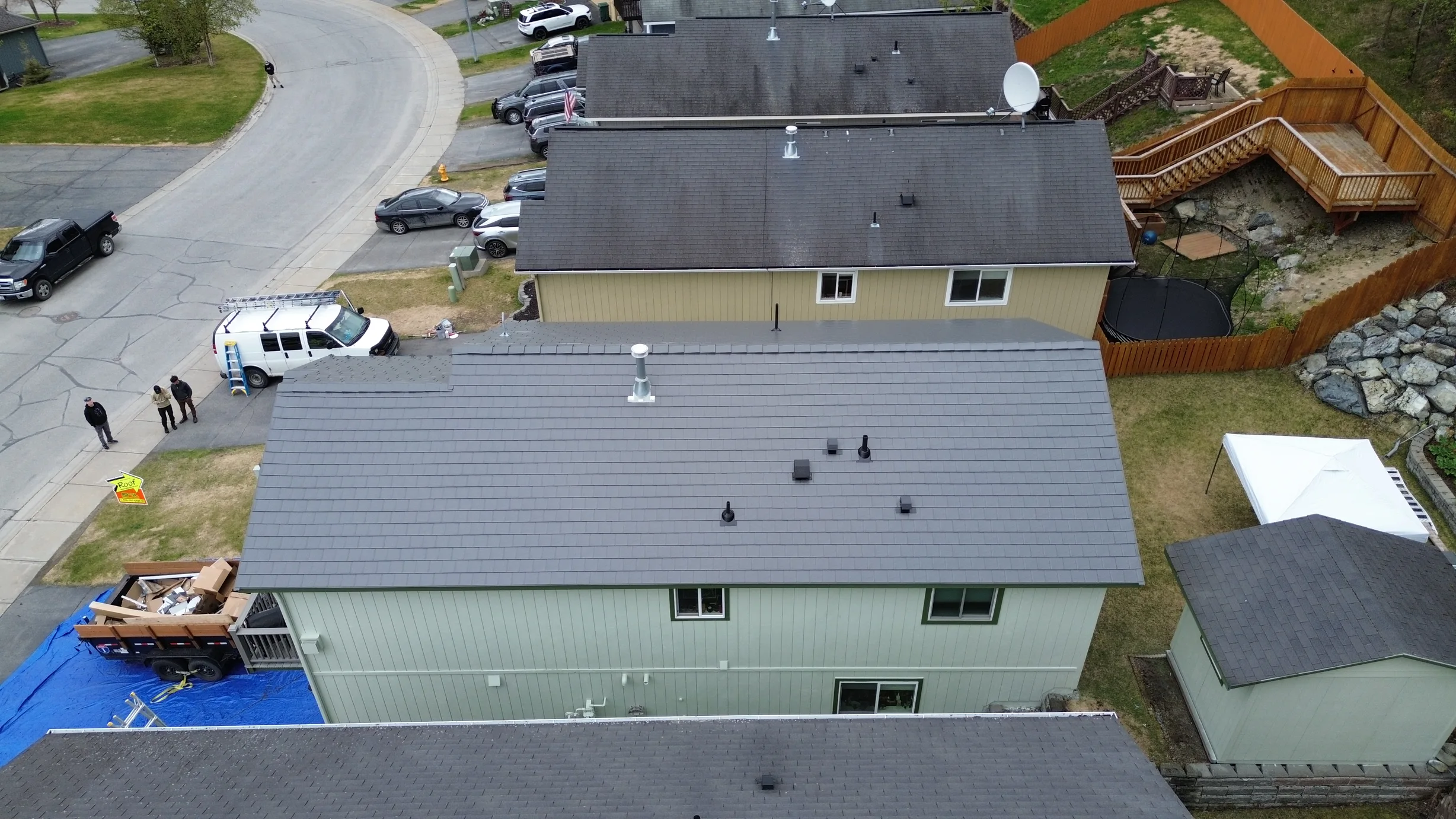 Modern home with light green siding and grey metal roof